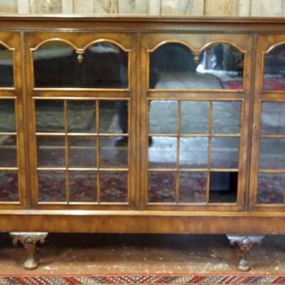 Sale Photo Thumbnail #248: 1248	WALNUT 4 DOOR BOOKCASE WITH REEDED STOP CHAMFERED SIDES, INDIVIDUALIZED GLASS PANE DOORS, ADJUSTABLE INTERIOR SHELVES, APPROXIMATELY 91 IN X 13 IN X 51 IN H, 1 GLASS PANE CRACKED AND 1 MISSING, SOME LOSS TO TRIM
