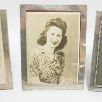 Sale Photo Thumbnail #234: 1234	GROUP OF 3 STERLING SILVER FRAMES, 2 MARKED GORHAM AND REED & BARTON, LARGEST APPROXIMATELY 6 IN X 8 IN
