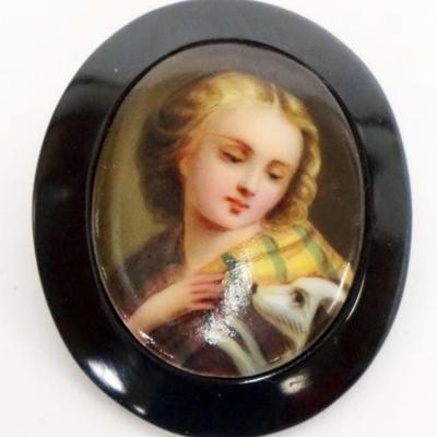 Sale Photo Thumbnail #132: 1132	PAINTED CENTER PORCELAIN BROACH, IMAGE OF WOMAN & HER DOG, APPROXIMATELY 1 3/4 IN X 2 IN
