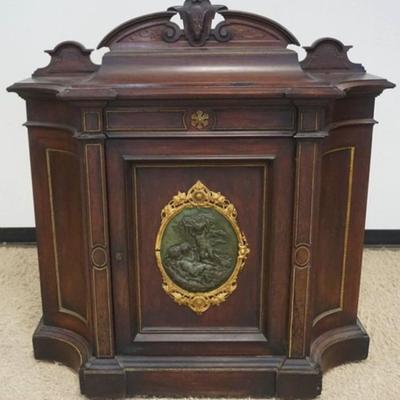 Sale Photo Thumbnail #250: 1250	ROSEWOOD VICTORIAN 1 DOOR CABINET WITH BRONZE MOUNTED CENTER PLAQUE & TRIM, QUILTED MAPLE INTERIOR, APPROXIMATELY 49 IN X 19 IN X 51 IN H, SOME LOSS TO TRIM
