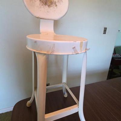 vintage industrial metal stool with a round seat and backrest