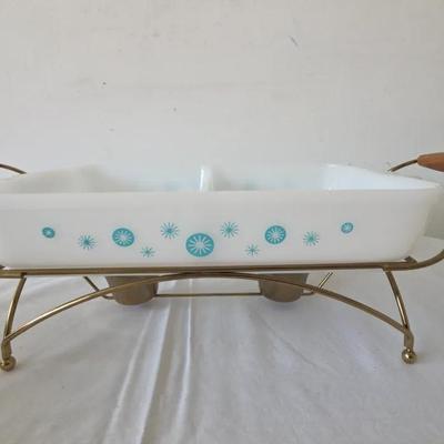 vintage Glasbake Atomic Starburst divided casserole dish with a brass wire serving frame.
