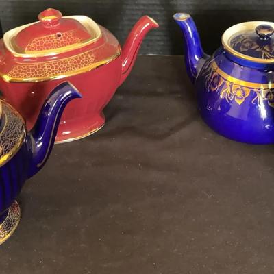 Four Hall Teapots with Gold Accents
