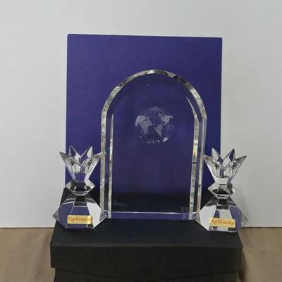 Two Candle Holders With Candle And A Clear Crystal Globe Achievement Award