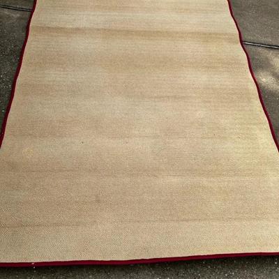 Tan Short Loop Rug With Deep Red Trim