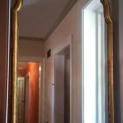 Elegant Wall Mirror with Gold Frame and Shaped Top