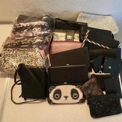 An Assortment of Various Black & Silver Wallets And Makeup Bags