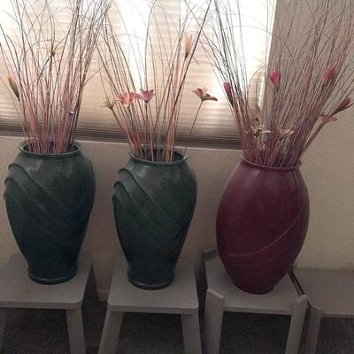 Green and Maroon Vases With Foliage And Gray Plant Stands 