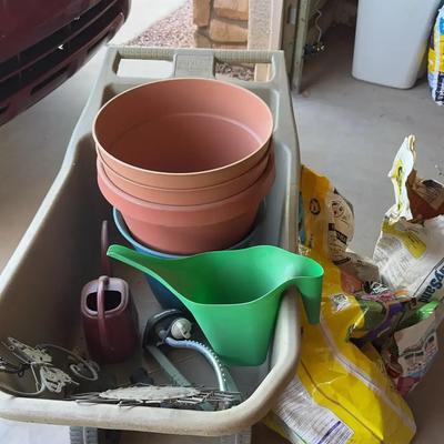 Garden Items. Wheel Barrel, Pots, Potting Soil, Watering Cans, Wall Decor