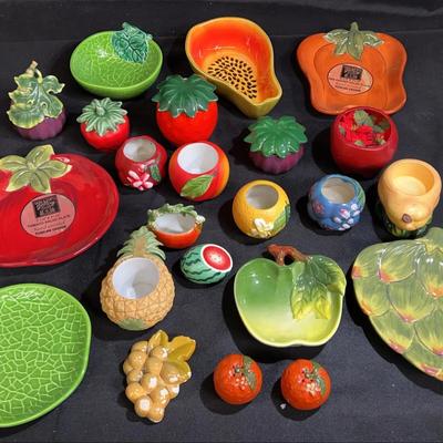 A collection of hand-painted ceramic fruit and vegetable-shaped tableware