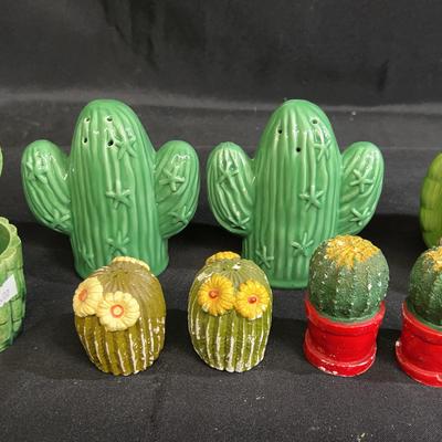 A collection of ceramic cactus-themed decorative items and salt and pepper shakers