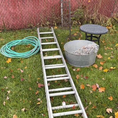 Ladder, Wrought Iron Planter, Garden Hose, Table And Fence Posts
