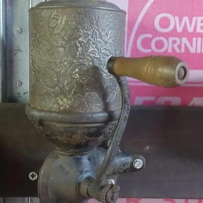 Antique Wall-Mount Coffee Grinder with Embossed Floral Design
