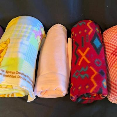 Lot 418: Lot of Fleece Fabric Rolls – Assorted Colors and Prints Including Winnie the Pooh