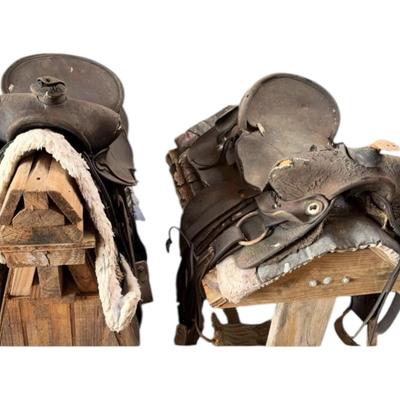 2 worn saddles, pads & stands