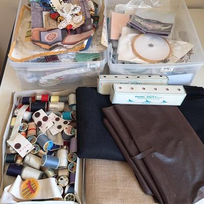 Lot of cross-stitching supplies, kits, thread and misc pieces of fabric