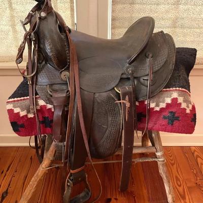 Saddle With Blanket And Spurs On Rustic Wooden Saddle Stand, Used As Decor