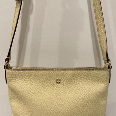 This is a Kate Spade New York pebbled leather handbag in a cream and Black