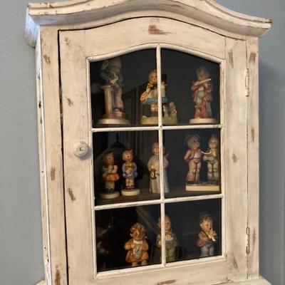 Sale Photo Thumbnail #10: Hummels in wall cabinet
