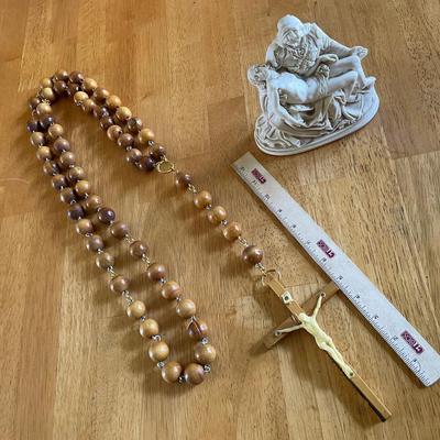 Oversized Rosary Beads And Small Religious Statue