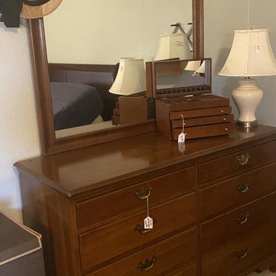Sale Photo Thumbnail #4: Solid cherry dresser with mirror by Thomasville. Has matching chest of drawers. 
Also shown: lamp,  jewelry box. 