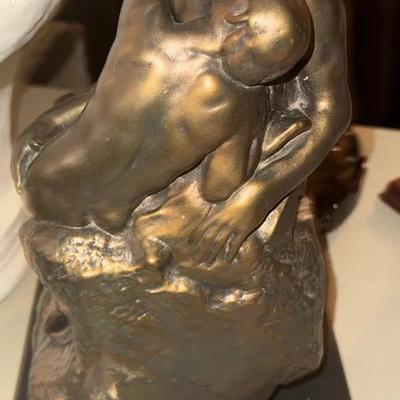 reproduction, of The Kiss (Le Baiser) by Auguste Rodin.  