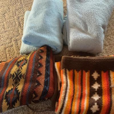 Two Medium Sized Light Blue Blankets And Two Medium Sized Southern Style Blankets