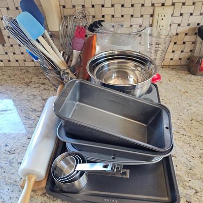 Lot #188 - Baking Tools Lot Includes: loaf pans, muffin pans, utensils, measuring cups, whisks, glass measuring bowl and more.
