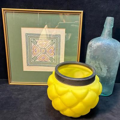 Antique glass bottle and framed cross stitch