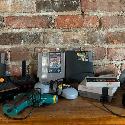 Nintendo And Atari Systems With Nintendo Games And Various Controllers