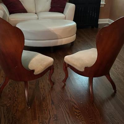 Pair of Victorian parlor chairs with solid backs. Pristine white leather sofa and ottoman. 