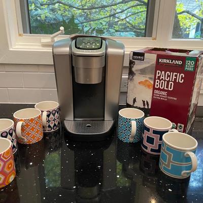 Keurig With Open Box Of K-Cups And Jonathan Adler Mugs