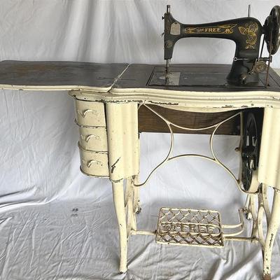 “The Free Co.” Sewing Treadle Machine on a Treadle Cabinet 