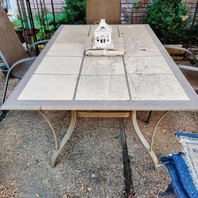 Wrought iron patio table w/ceramic tile inserts, and 4 metal/mesh patio chairs. $125