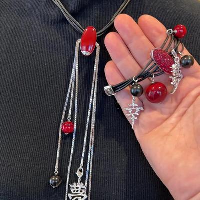 Contemporary Swarovski necklace and bracelet with Asian-inspired charms and crystal accents