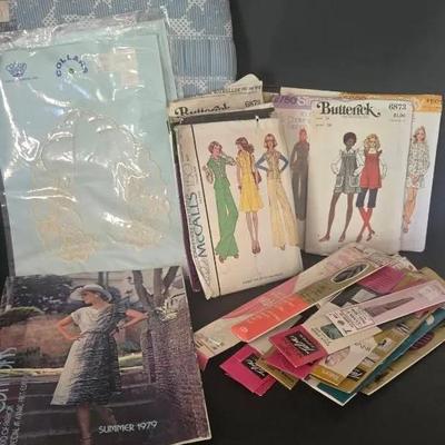 Vintage Sewing Patterns, Zippers And Lace Collars With Vintage Sewing Storage Or Stool