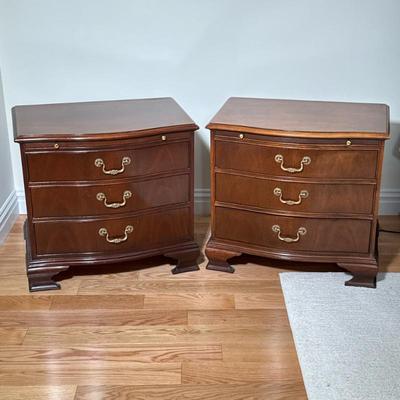 PAIR THREE DRAWER BAKER NIGHTSTANDS | Of dark wood with brass handles and pull-out shelves. Dimensions: h. 25.5 x w. 27 x d. 18 in
