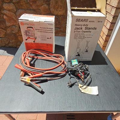 Jack Stands,  Utility Work  Light. Jumper Cables,  And Trickle charger