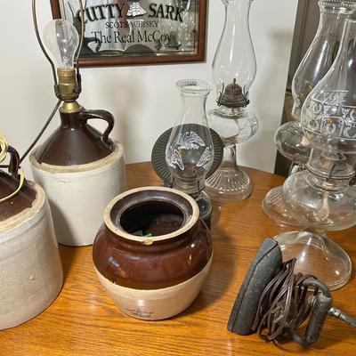 Group Of Crocks, Oil Lamps And Sad Iron