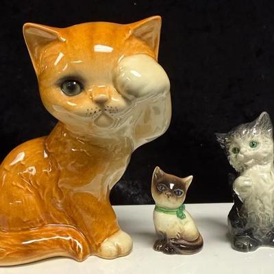 Vintage porcelain cat figurines, with the large orange cat being a Goebel Persian cat figurine