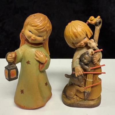 Two Hand-carved wooden figurines by the Italian company ANRI, based on designs by artist Juan Ferrán