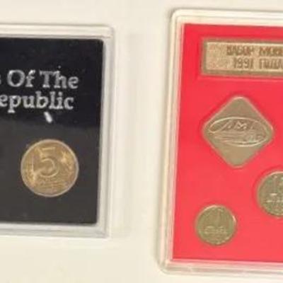 “First Coins Of The Russian Republic" and the other a 1991 Soviet Union coin set.