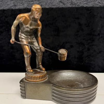 vintage bronze sculpture of a foundry worker, sometimes identified as a trophy or ashtray
