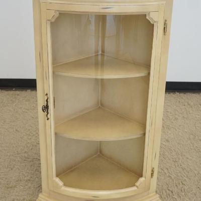 1210	1 DOOR CORNER CURVED GLASS CURIO CABINET WITH 2 INTERIOR SHELVES IN IVORY FINISH, APPROXIMATELY 24 IN X 17 IN X 44 IN H

