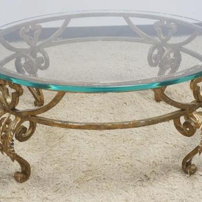 1236	ROUND GLASS TOP COCKTAIL TABLE ON FANCY WROUGHT IRON BASE, APPROXIMATELY 42 IN ROUND X 19 IN H
