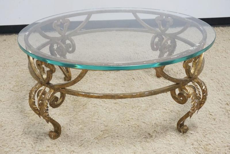 Sale Photo Thumbnail #237: 1236	ROUND GLASS TOP COCKTAIL TABLE ON FANCY WROUGHT IRON BASE, APPROXIMATELY 42 IN ROUND X 19 IN H
