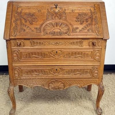 1287	CARVED OAK SLANT FRONT DESK WITH KEY AND 2 DRAWERS AND PANELED SIDES, APPROXIMATELY 33 IN X 16 IN X 38 IN H
