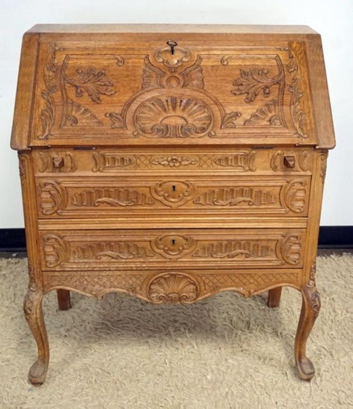 Sale Photo Thumbnail #288: 1287	CARVED OAK SLANT FRONT DESK WITH KEY AND 2 DRAWERS AND PANELED SIDES, APPROXIMATELY 33 IN X 16 IN X 38 IN H
