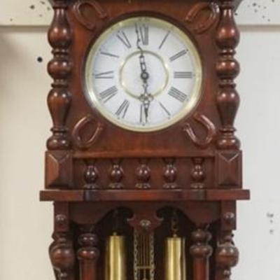 1195	WEIGHT DRIVEN GERMAN WALL CLOCK WITH IMAGE OF PRANCING HORSE ON CREST, HORSE SHOE DESIGN ON CLOCK DOOR, APPROXIMATELY 54 IN H
