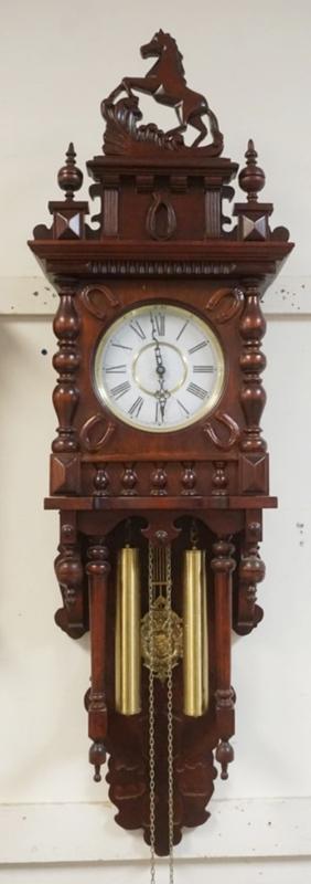 Sale Photo Thumbnail #196: 1195	WEIGHT DRIVEN GERMAN WALL CLOCK WITH IMAGE OF PRANCING HORSE ON CREST, HORSE SHOE DESIGN ON CLOCK DOOR, APPROXIMATELY 54 IN H
